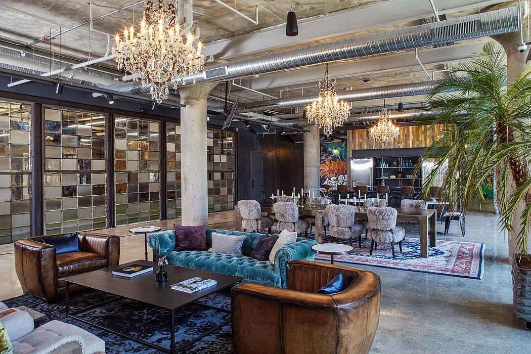 Loft-style interior with crystal chandeliers, plush sofas, and industrial decor.