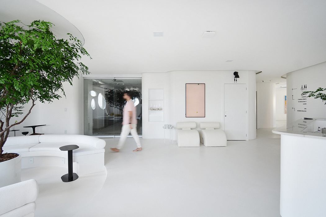 Contemporary open-plan living space with lush greenery, minimalist furnishings, and natural lighting.