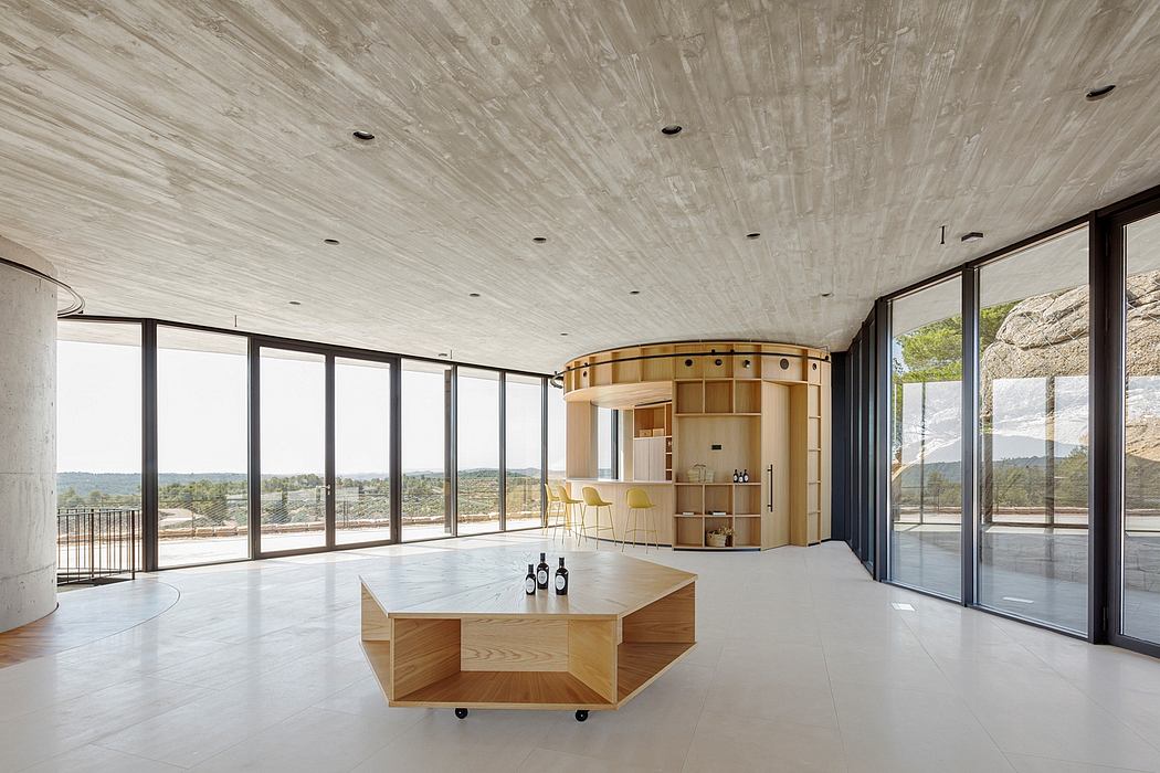 Minimalist interior with floor-to-ceiling windows and a central wooden structure.
