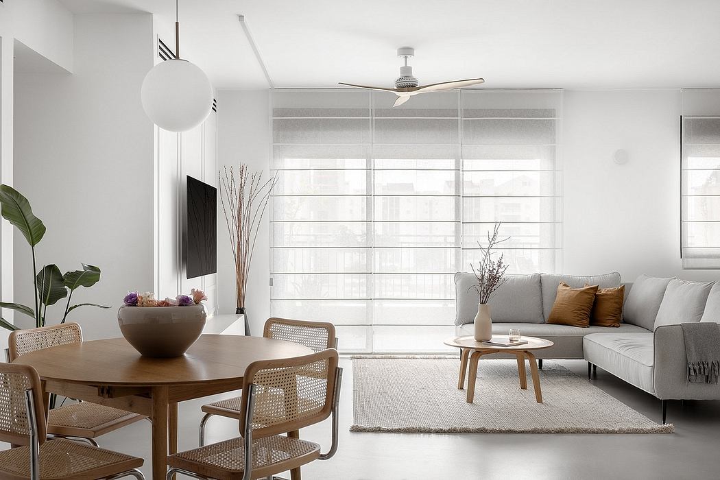 Contemporary minimalist living room with neutral tones and wooden furniture.