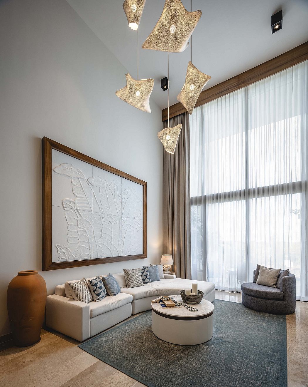 Contemporary living room with star-shaped pendant lights and neutral tones.