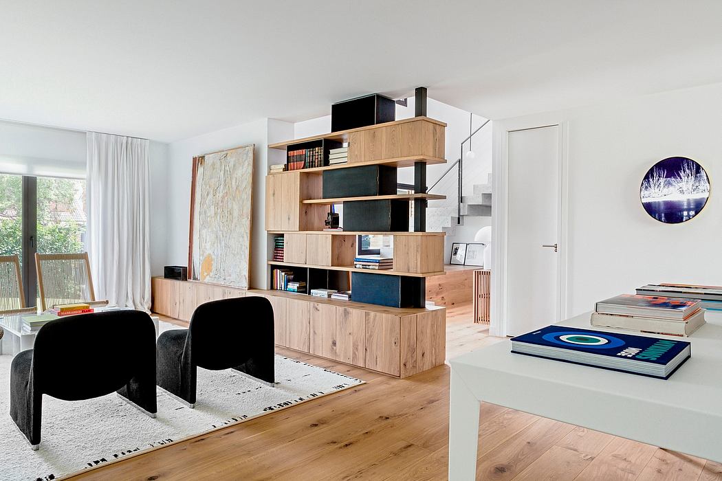Airy, minimalist living space with wooden shelving, modern artwork, and sleek furnishings.