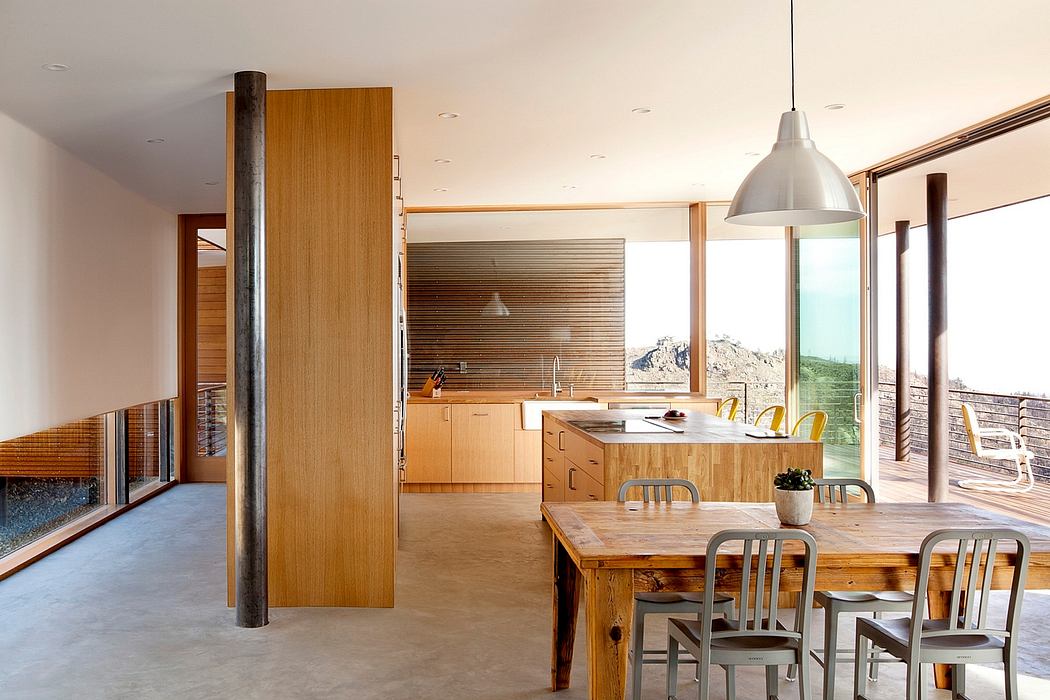 Modern kitchen with wooden furniture and ocean view.