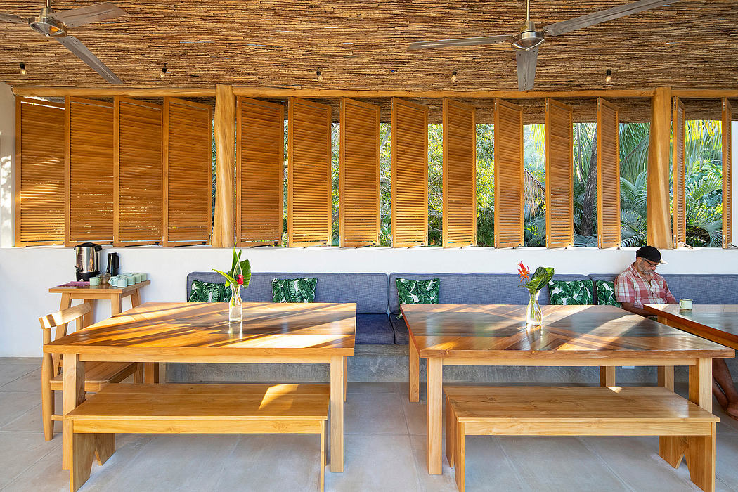 Tropical-themed café with bamboo shutters and wooden tables.