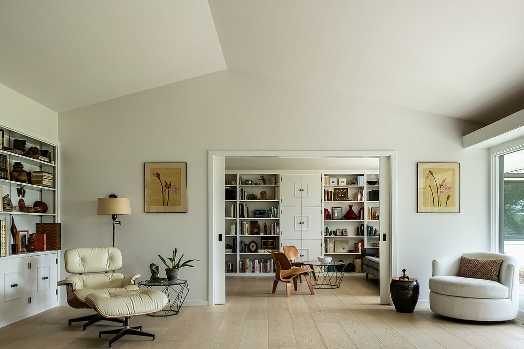 Spacious living area with modern furniture, built-in shelving, and framed artwork.