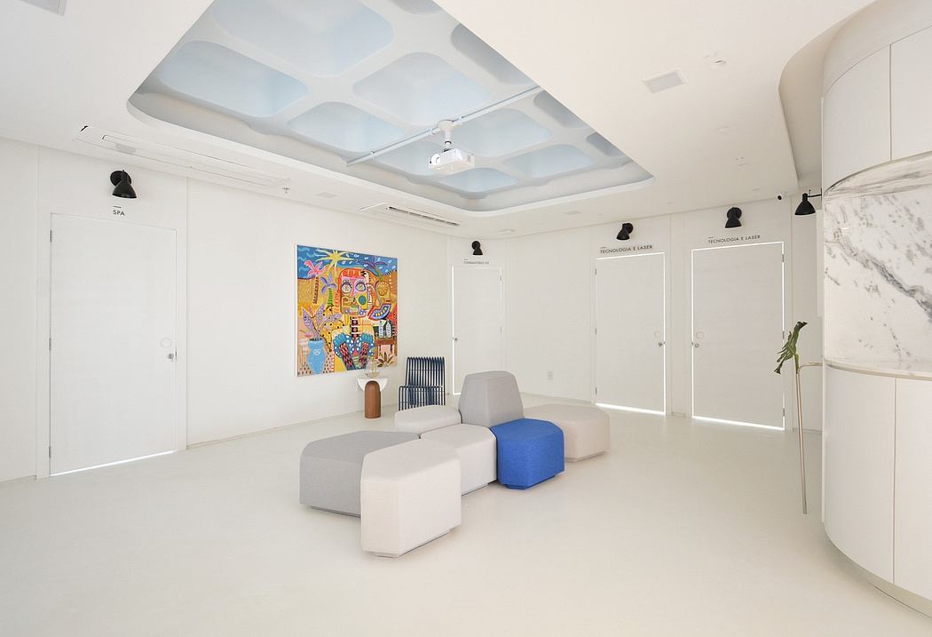 Bright, spacious interior with modern, minimalist furniture and vibrant artwork on the walls.