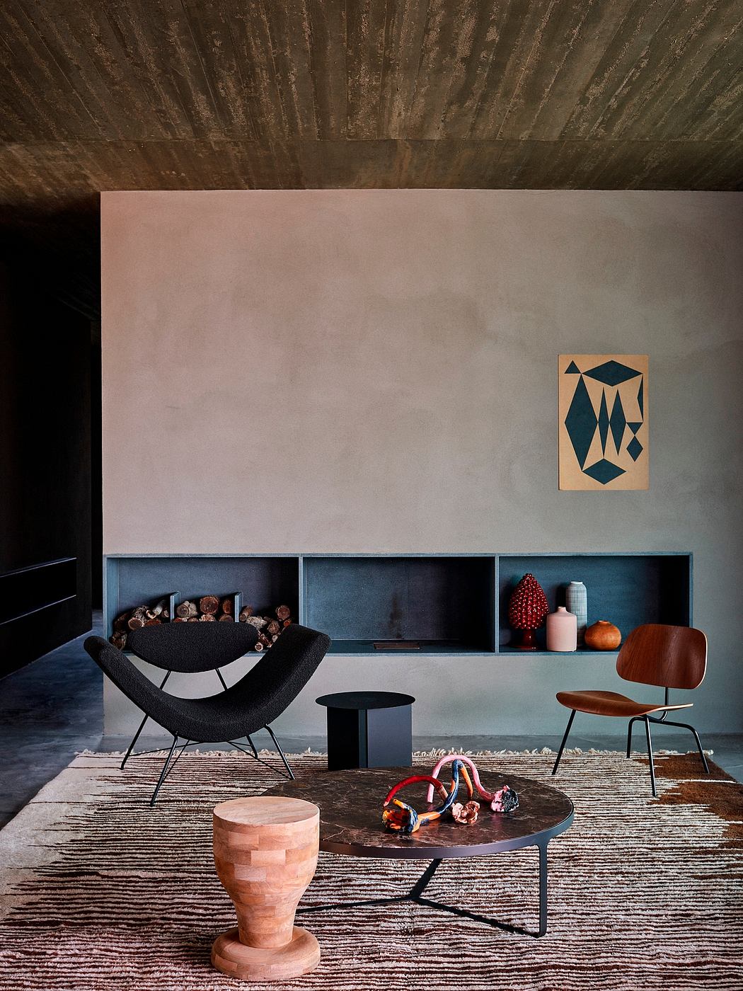 Contemporary living room with minimalist decor and concrete finishes.