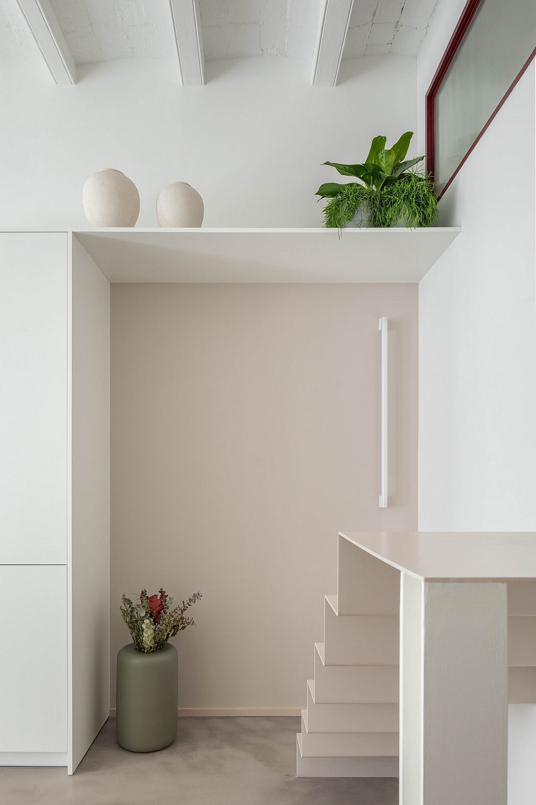 Minimalist interior with white stairs, a high shelf with plants, and beige walls