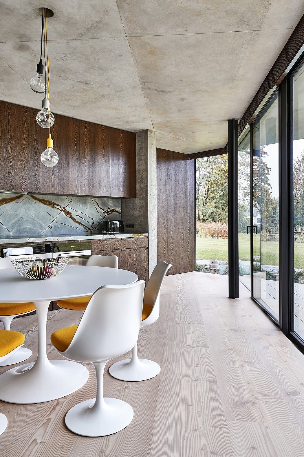 Contemporary dining space with floor-to-ceiling windows and wood accents.