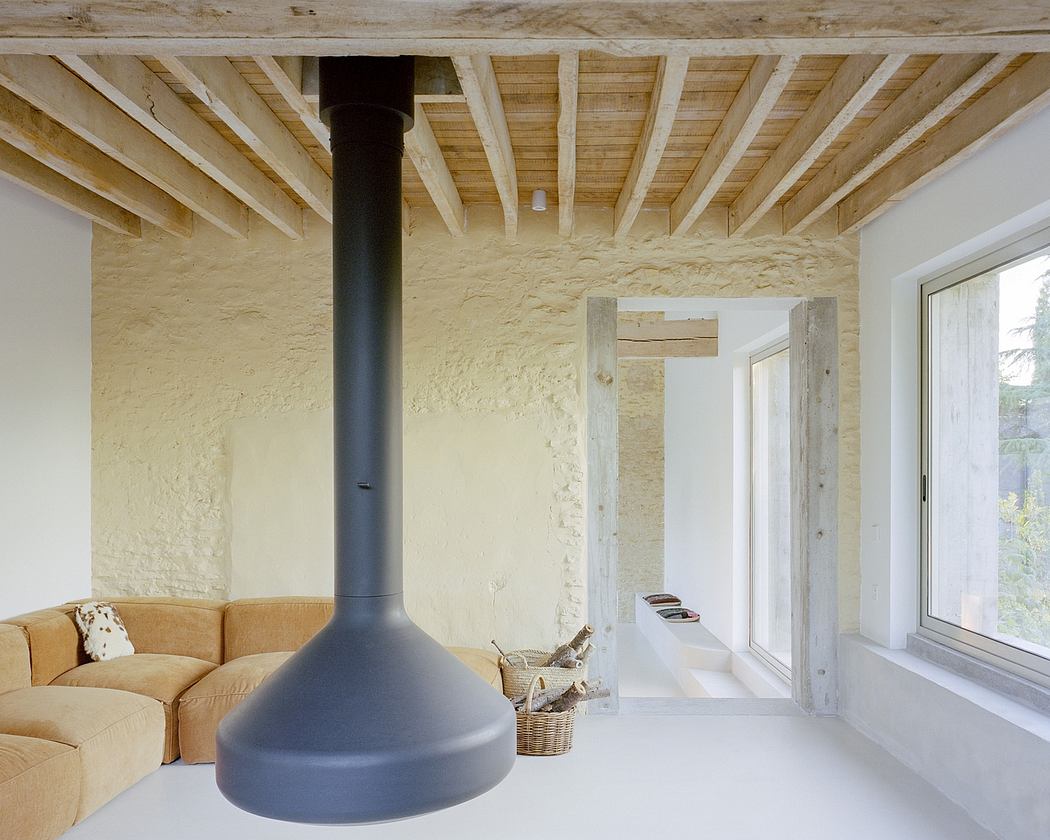 Minimalistic interior with a suspended fireplace, exposed wooden beams, and a beige corner