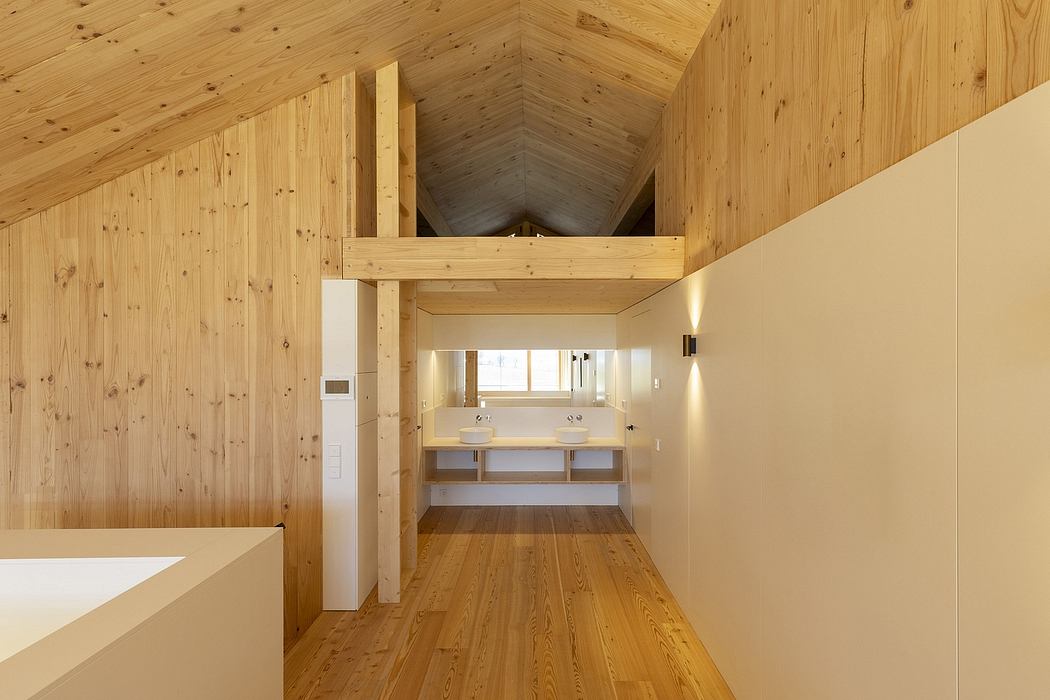 The image showcases a modern, minimalist bathroom design with a vaulted wooden ceiling and ample natural light.