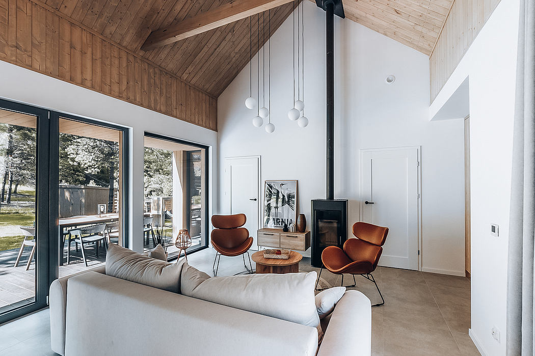 Rustic cabin interior with wood-paneled ceiling, modern furniture, and large windows.