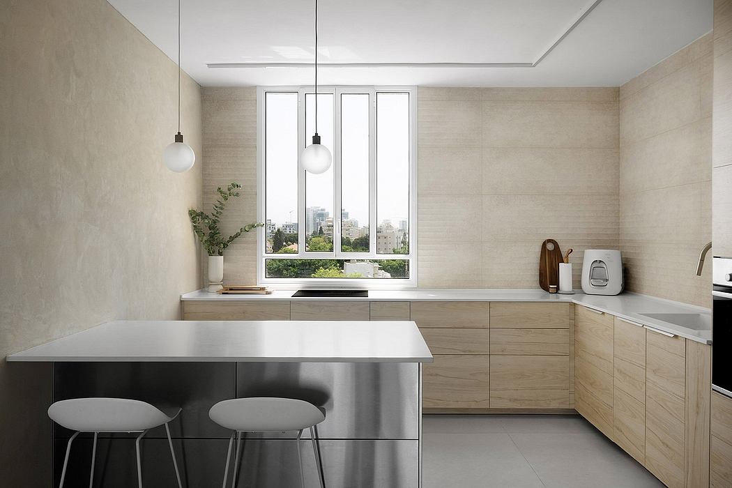 Minimalist kitchen with light wood cabinets and pendant lights.