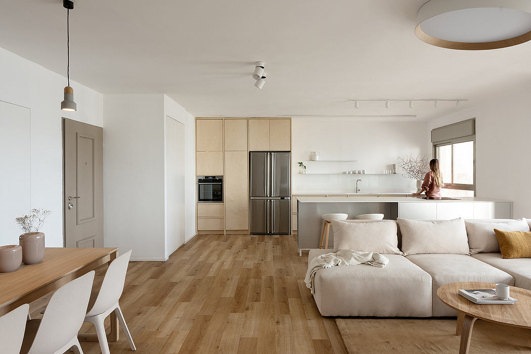 Minimalist apartment interior with light wood floors and neutral tones.