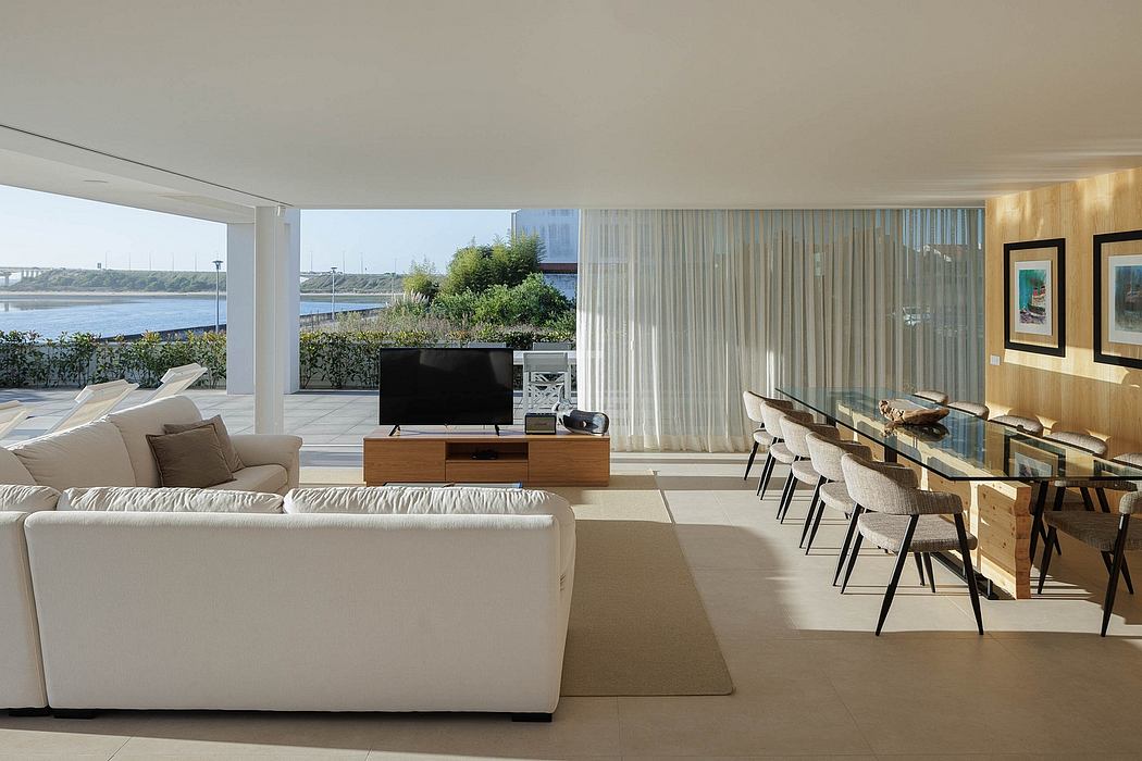 Spacious modern living room with wood paneling, large windows, and stylish dining area.