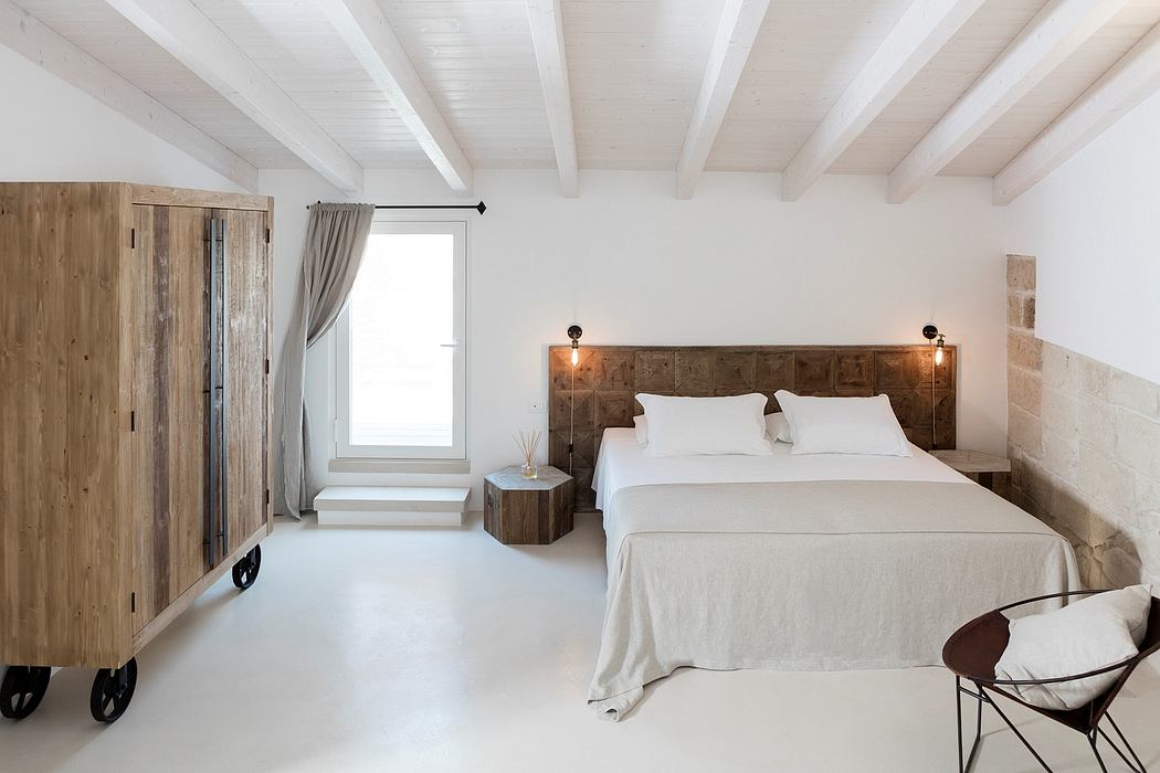Spacious, minimalist bedroom with wooden furnishings, vaulted ceiling, and rustic charm.