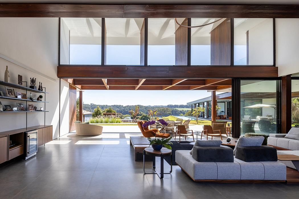 Sleek open-plan living space with expansive windows and wooden accents.