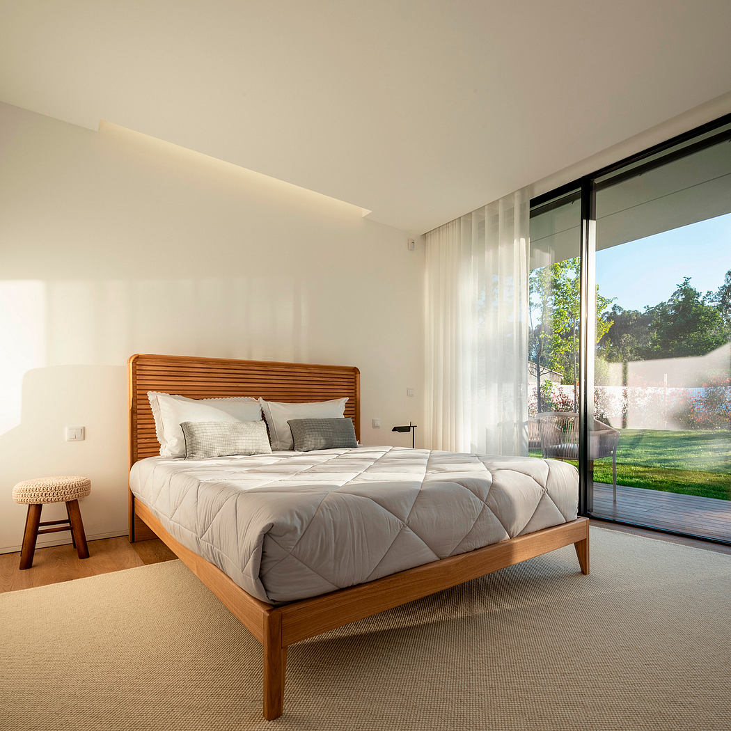 Modern bedroom with large window and garden view.