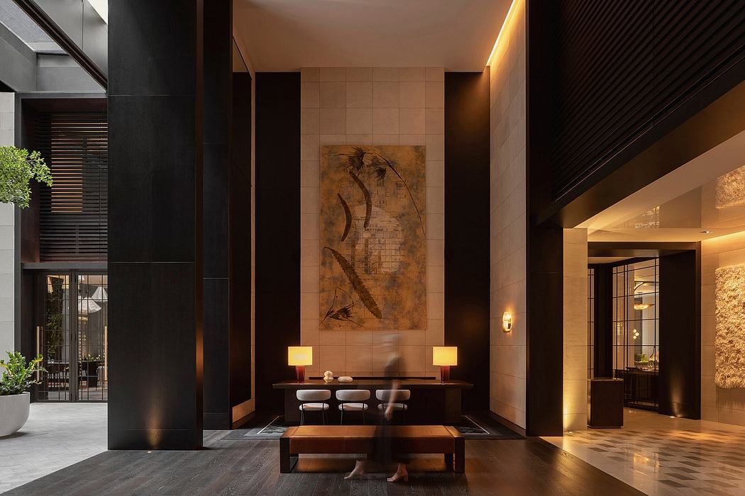 Contemporary interior with artistic wall piece, seating area, and ambient lighting.