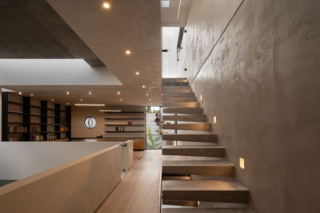 Modern interior with concrete walls, wooden stairs, and minimalist bookshelf.