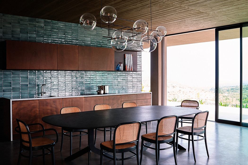 Contemporary dining area with oval table and glass bubble chandelier.