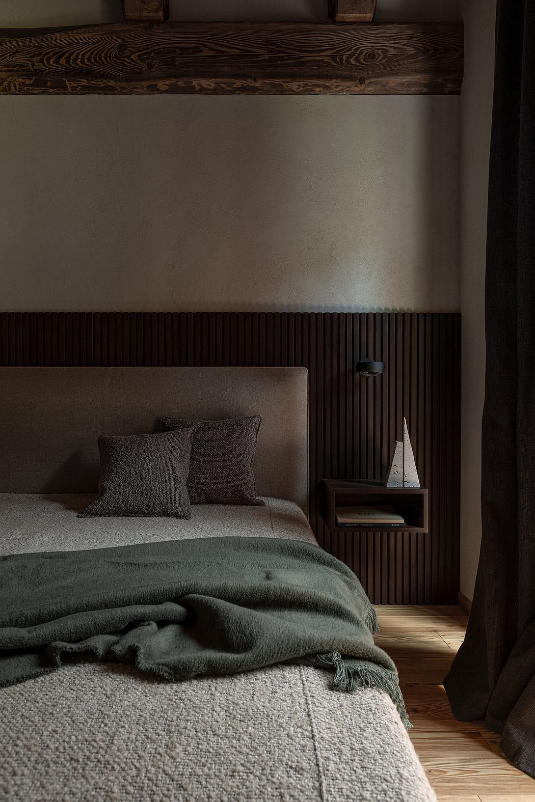 Contemporary bedroom with dark wood accents and green textiles.