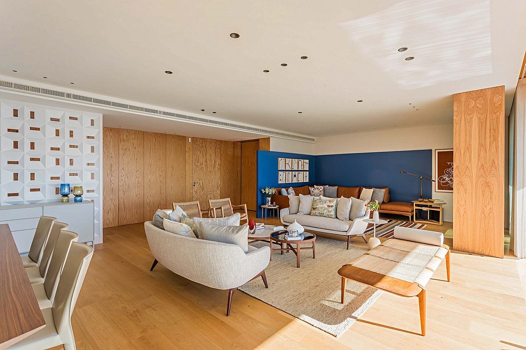 Contemporary living room with sleek furniture and wood paneling.