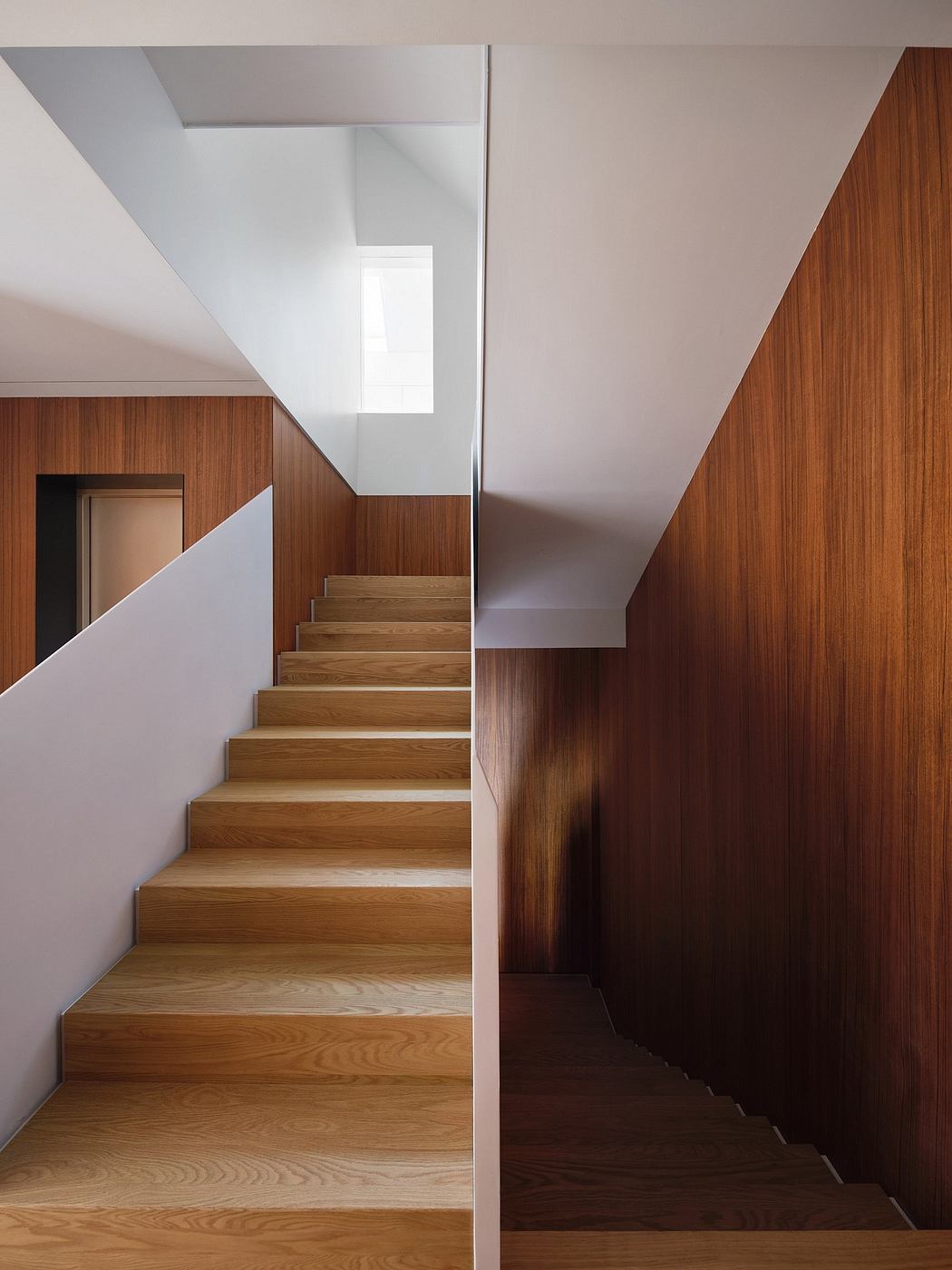 Modern wooden stairs in a minimalist interior design with clean lines.