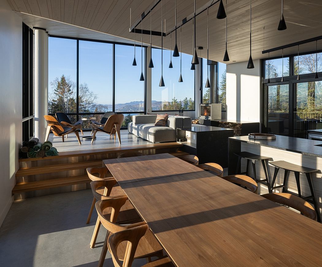 Modern dining room with large windows and mountain view.