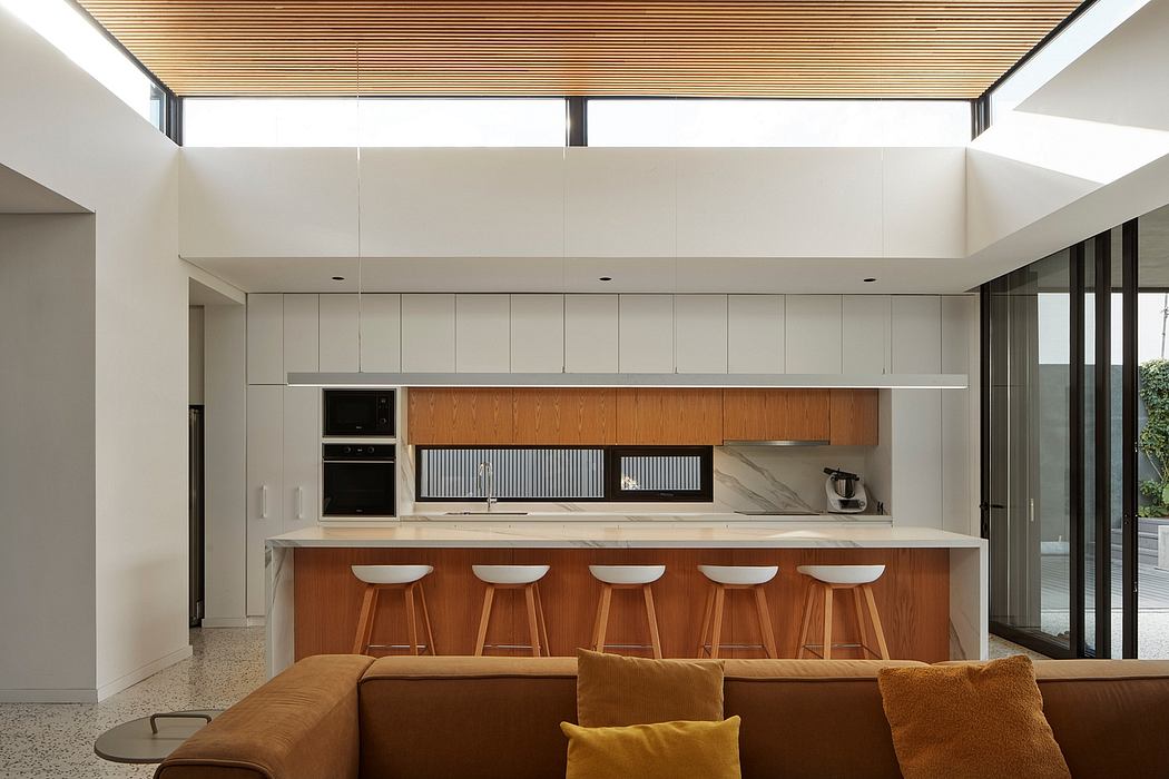 Modern kitchen interior with wooden bar stools and ceiling.