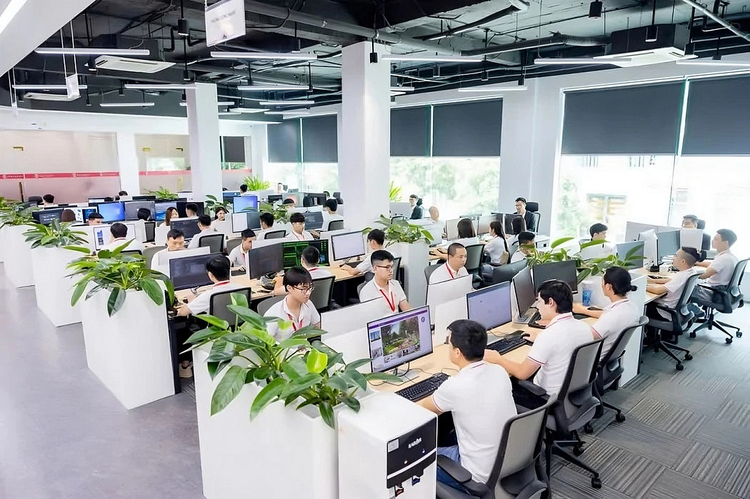 An open-plan office space with modern, minimalist design and ample greenery.