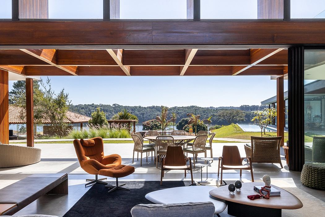 Modern living room with large windows overlooking a scenic outdoor setting.