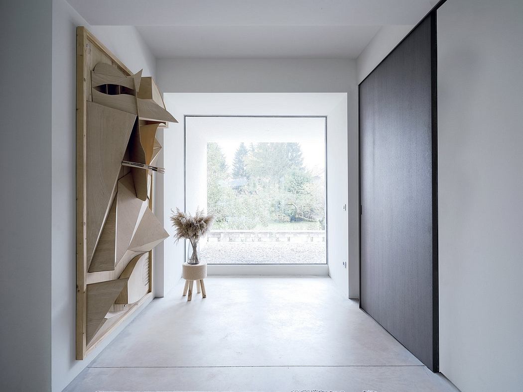 Minimalist room with large window, wooden shelving, and simple vase decor.