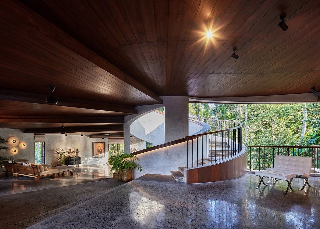Expansive interior with wooden beams, spiral staircase, and lush outdoor views.