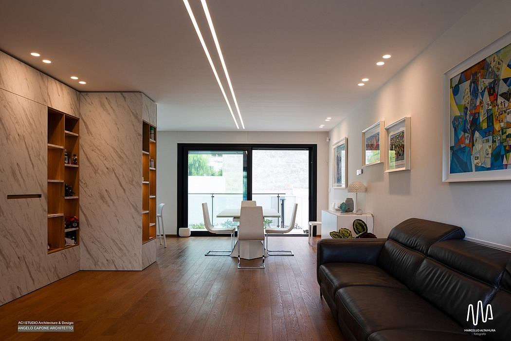 Sleek modern interior with marble built-in units, wood floors, and contemporary furnishings.