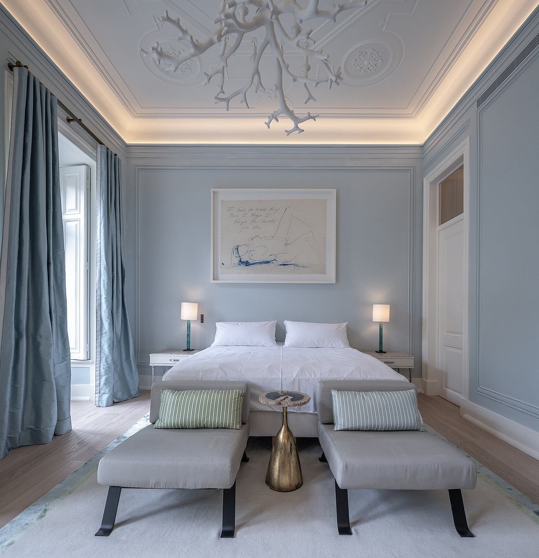 Elegant bedroom with classic moulding and a unique white chandelier.