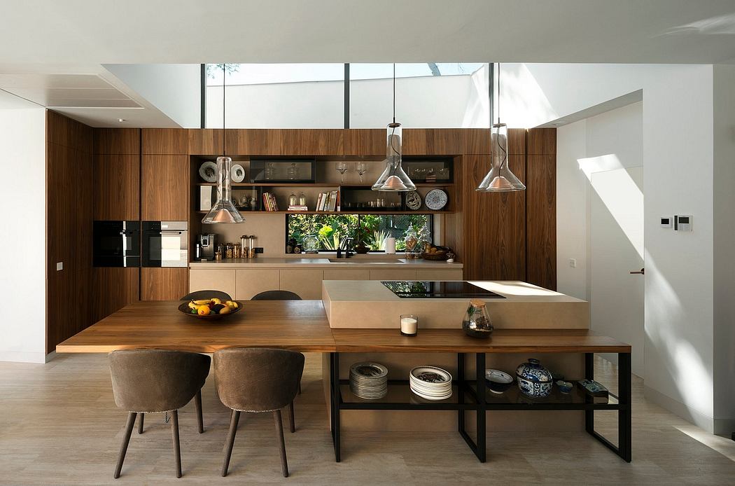 Spacious contemporary kitchen with wooden cabinetry, large windows, and industrial-style fixtures.
