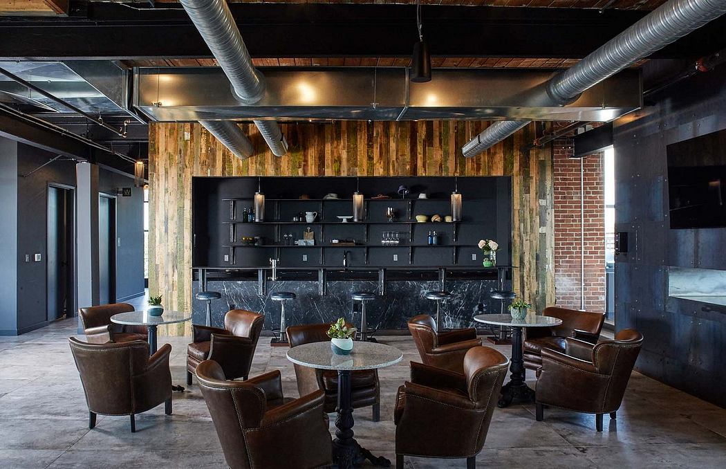 Rustic industrial space with exposed brick walls, wood paneling, and leather furniture.