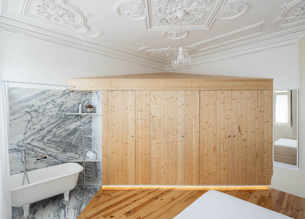 Modern room with ornate ceiling and wooden wall divider.