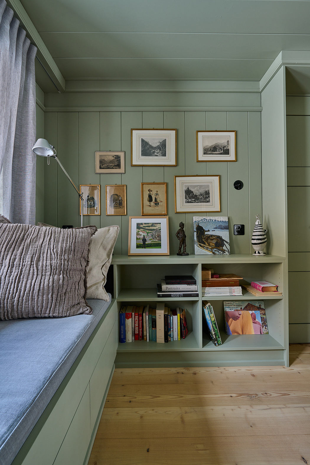 Cozy reading nook with built-in shelving and gallery wall