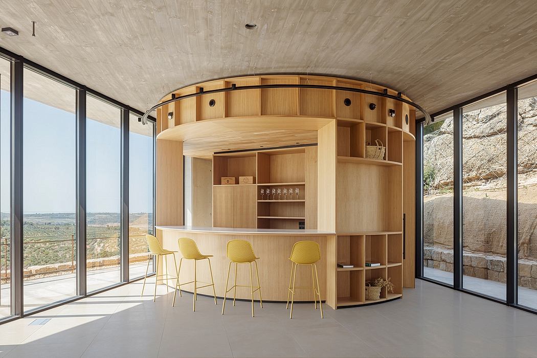 Circular wooden kitchenette with yellow chairs and panoramic windows