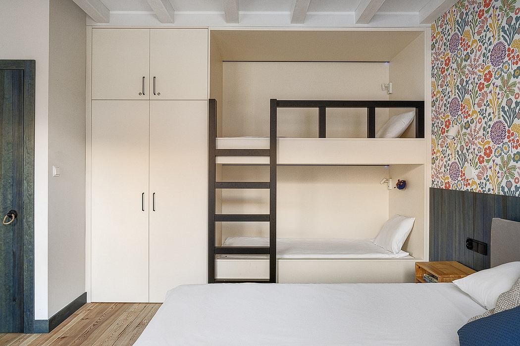 Modern bedroom with built-in bunk beds, cabinets, and patterned wallpaper.