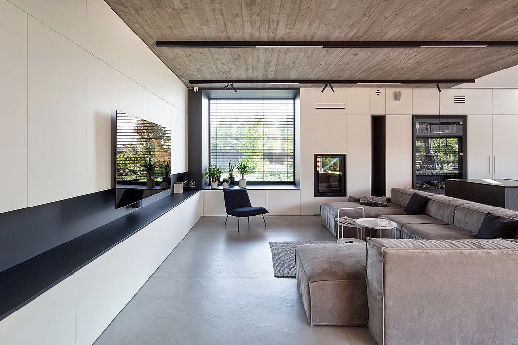 Contemporary living room with polished concrete floor and wood ceiling.