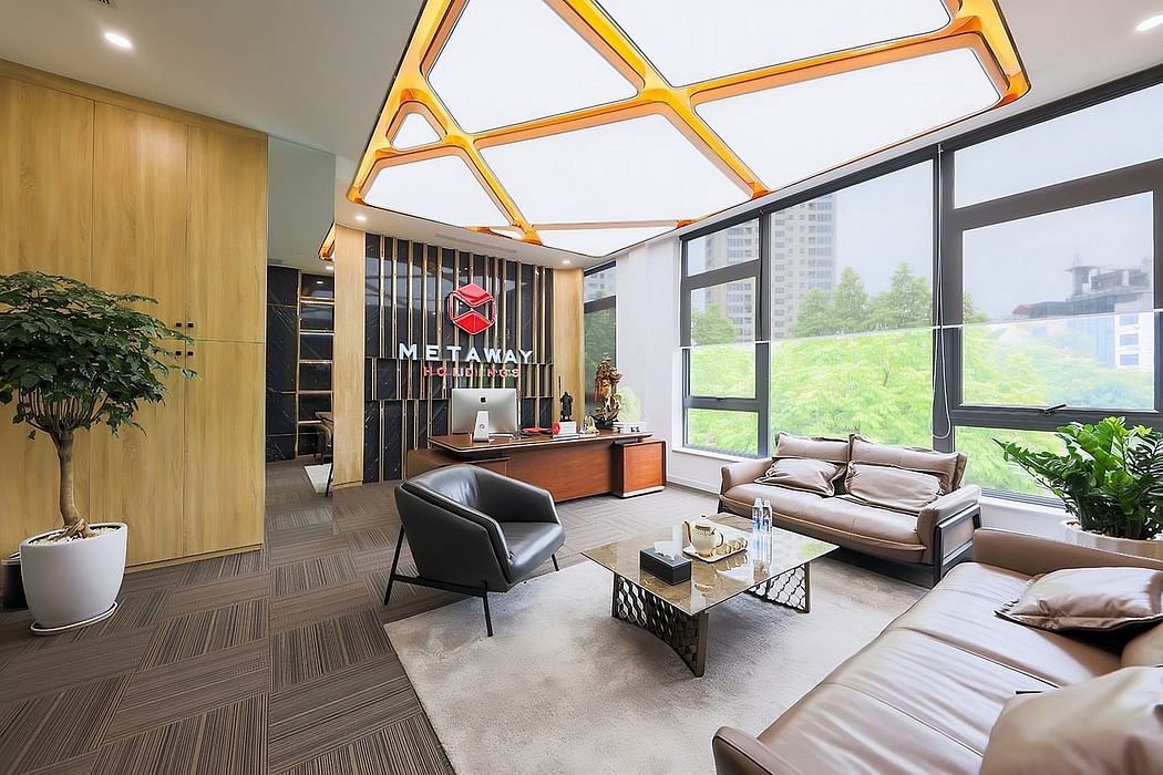 Spacious office lobby with modern geometric lighting, wood paneling, and panoramic views.