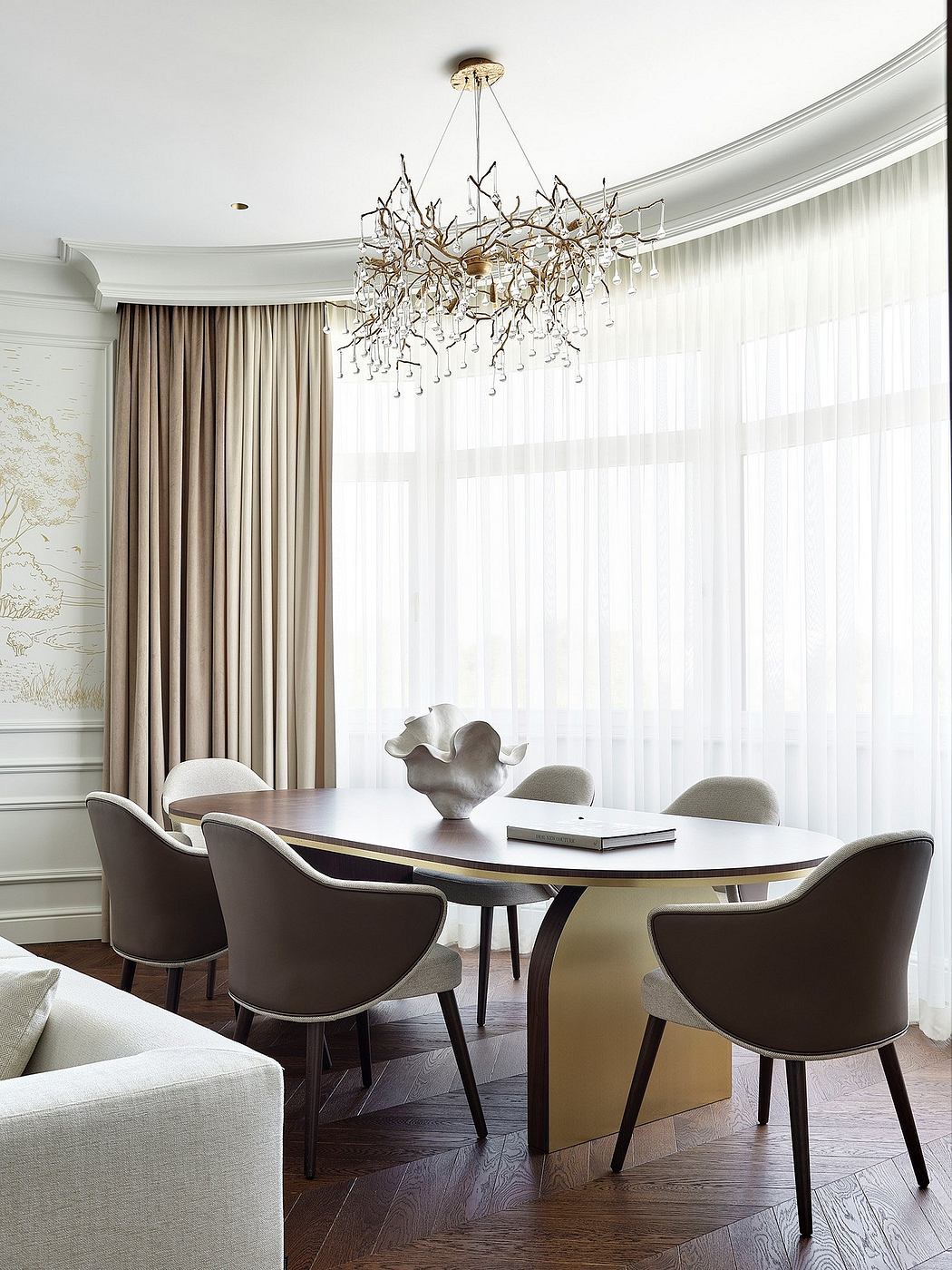 Elegant dining room with curved curtains, a striking chandelier, and stylish furniture.