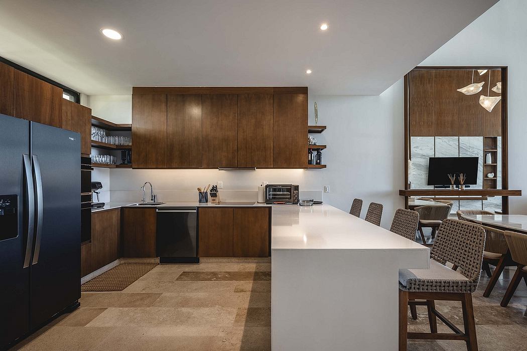 Contemporary kitchen with wood cabinets, white countertops, and stainless steel appliances.