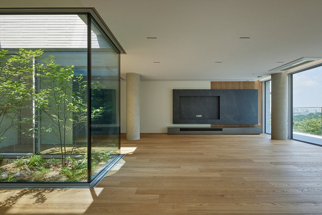 Minimalist interior with large windows and wooden floors.