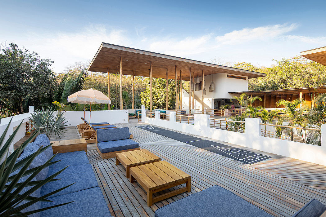 Contemporary patio with wooden deck, loungers, and expansive roof.