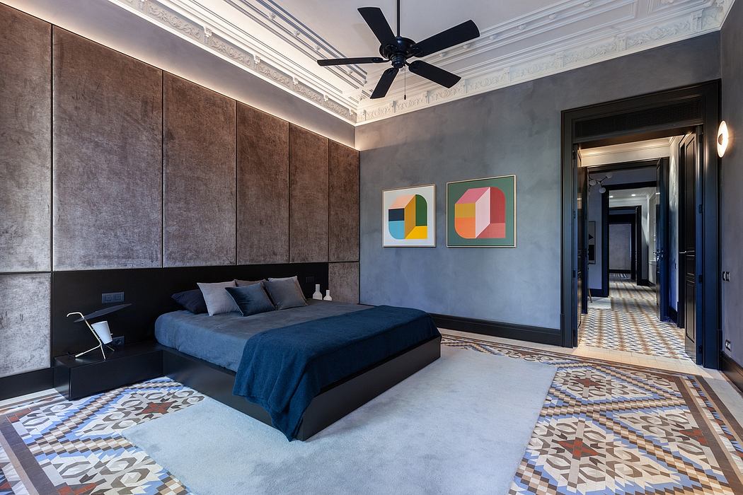 Elegant bedroom interior with patterned floor, modern art, and dark ceiling fan