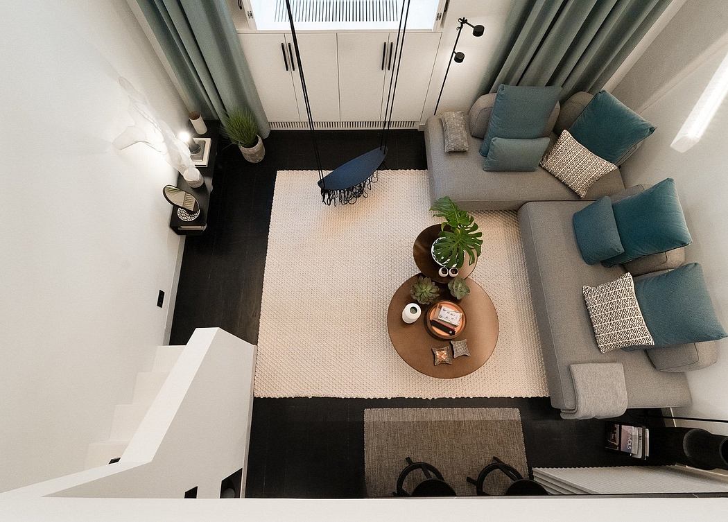 Top-down view of a modern living room with a sofa, armchair, and